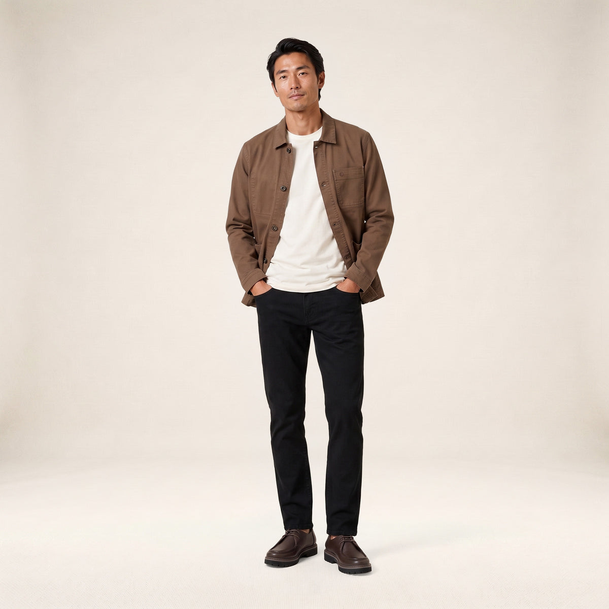 A brown Wendel work jacket worn by a model, shown from the front in a full-length shot.