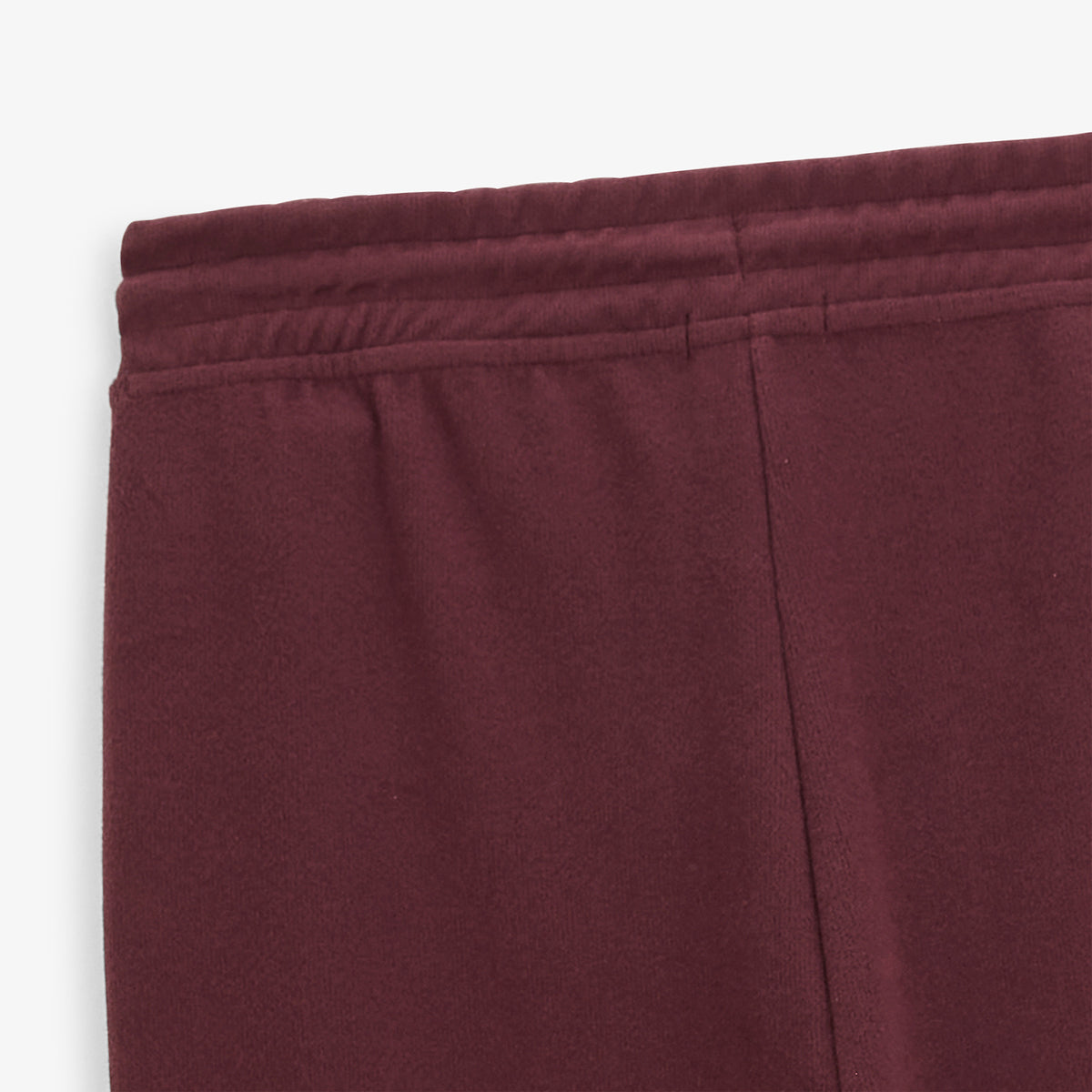 Détail de la taille élastiquée et de la poche arrière du jogging Paolo rouge.