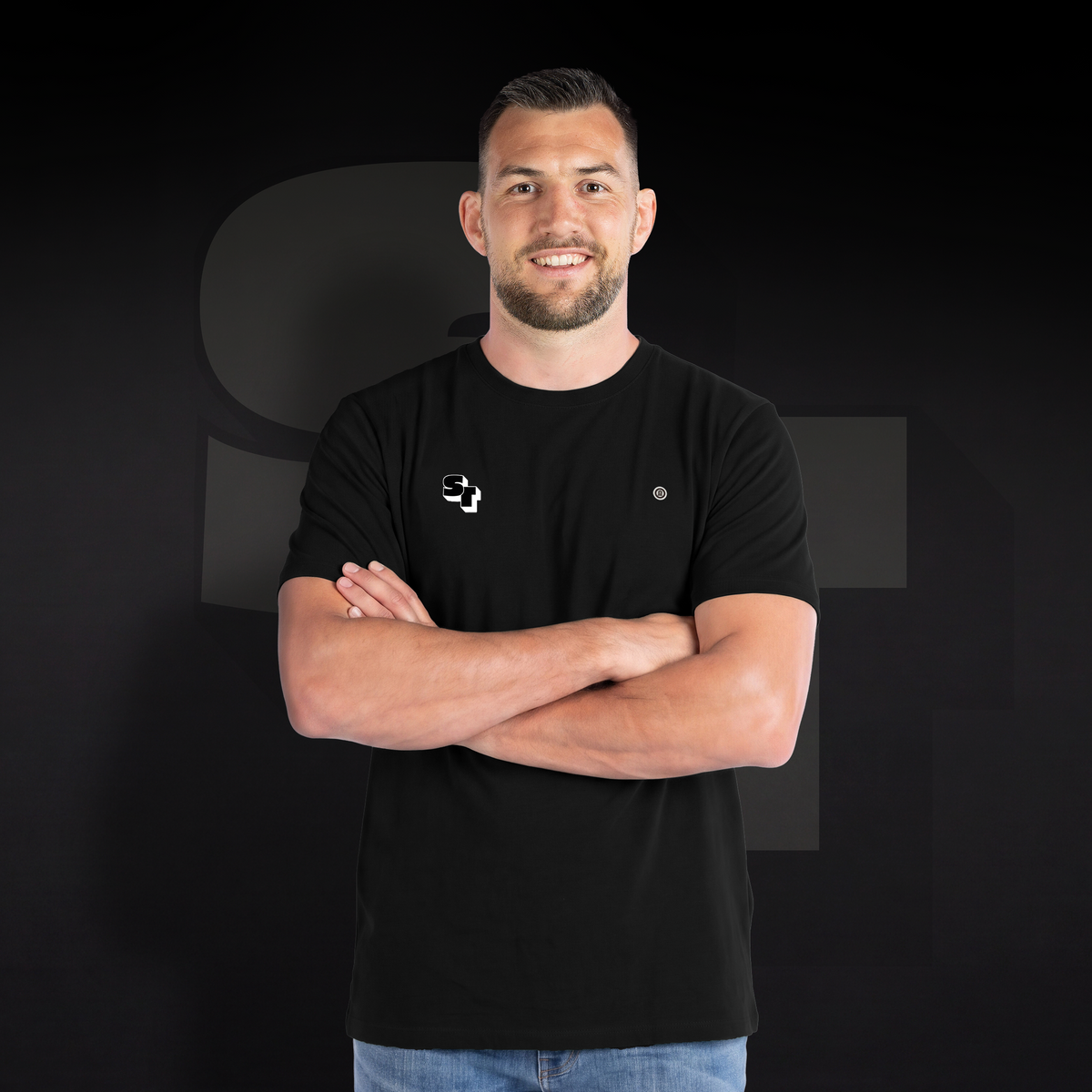 A black "ST 3D" Stade Toulousain T-shirt worn from the front by a model with his arms crossed.
